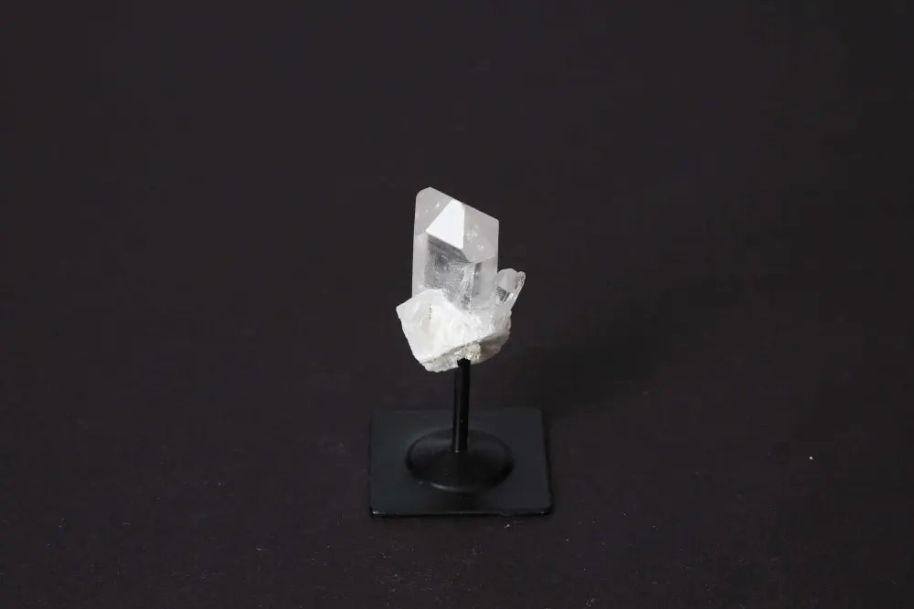 Clear Quartz on a sleek metal stand, symbolizing elegance and spirituality, perfect for amplifying energy and harmonizing the mind.