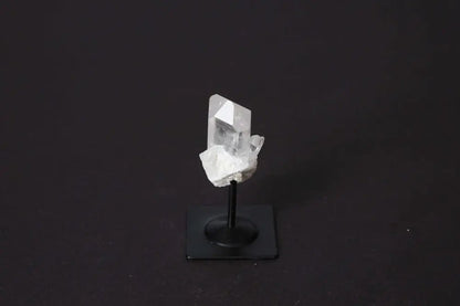 Clear Quartz on a sleek metal stand, symbolizing elegance and spirituality, perfect for amplifying energy and harmonizing the mind.