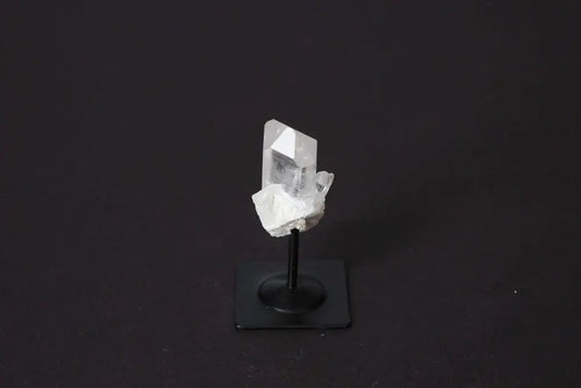 Clear Quartz on a sleek metal stand, symbolizing elegance and spirituality, perfect for amplifying energy and harmonizing the mind.