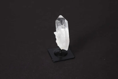 Clear Quartz crystal on a metal stand, perfect for home decor and spiritual focus, known for energy amplification and harmonization.