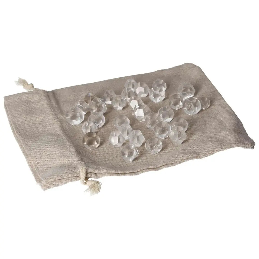 Clear Quartz geometric spheres on a beige fabric pouch for energy purification and harmonizing space.
