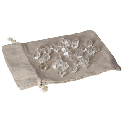 Clear Quartz geometric spheres on a beige fabric pouch for energy purification and harmonizing space.