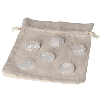 Clear quartz small palmstones on a drawstring cloth bag for energy purification and harmonizing the mind and space.