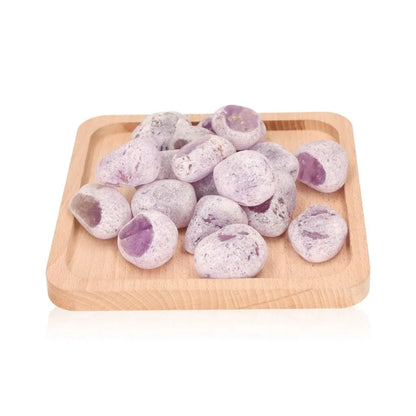 Emma Eggs, smooth and oval river stones, displayed on wooden tray, known for calming energy and natural polish from New Zealand rivers.