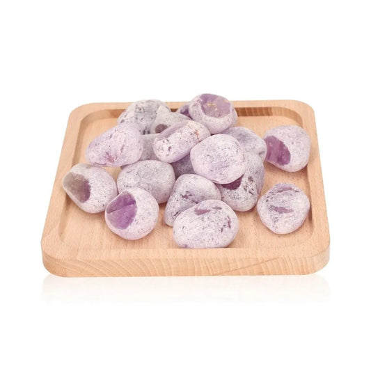 Emma Eggs, smooth and oval river stones, displayed on wooden tray, known for calming energy and natural polish from New Zealand rivers.