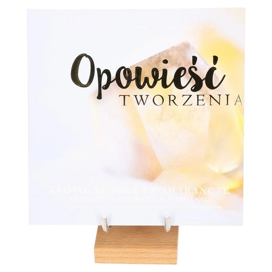Cover of 'Golden Sunlight and Oranges - The Essence of Creation' book on a wooden stand