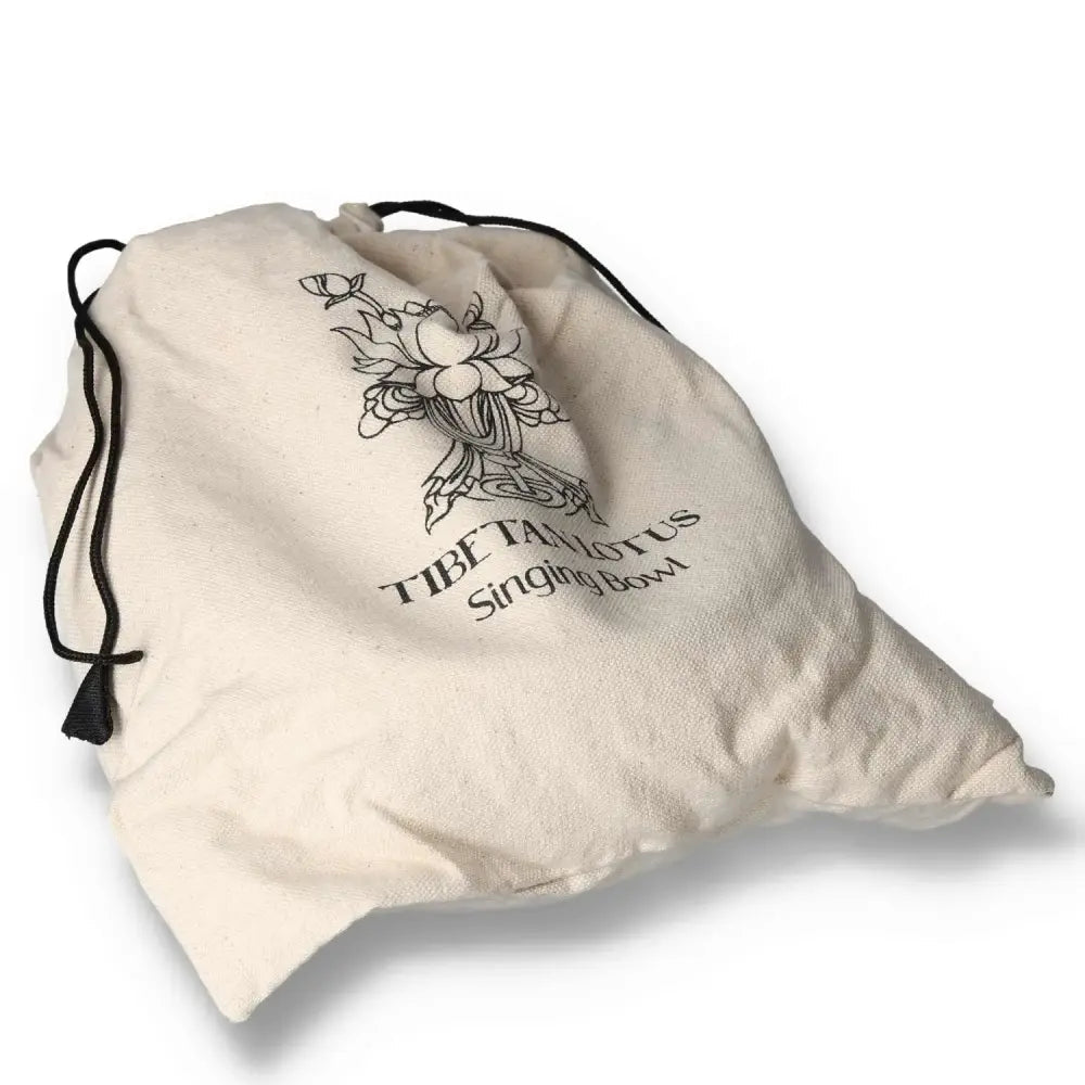 Cotton drawstring bag for Hand Beaten & Engraved Lotus Singing Bowl Gift Set, featuring a lotus design, 14cm, perfect for gifting.