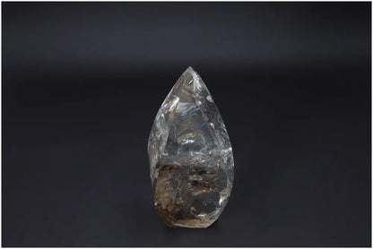 Large Lemurian Quartz Obelisk on dark background, highlighting its clear, natural crystalline structure and ethereal beauty.