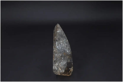Large Lemurian Quartz Obelisk on dark background, showcasing its natural clarity and healing properties.