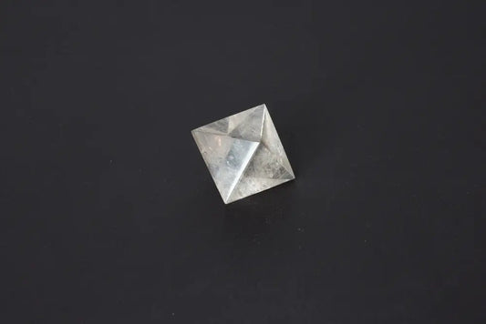 Lemurian Quartz Double Pyramid 3 cm displaying sacred geometry against a dark background, highlighting its ethereal clarity and striations.