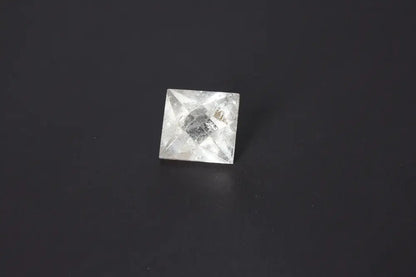 Lemurian Quartz Double Pyramid 3.5 cm, showcasing sacred geometry with spiritual significance, on a dark background.