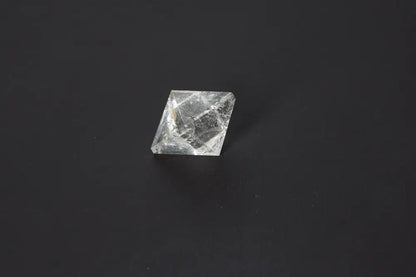 Lemurian Quartz Double Pyramid 3.5 cm showcasing sacred geometry on a dark background, known for awakening intuition and inner truth.