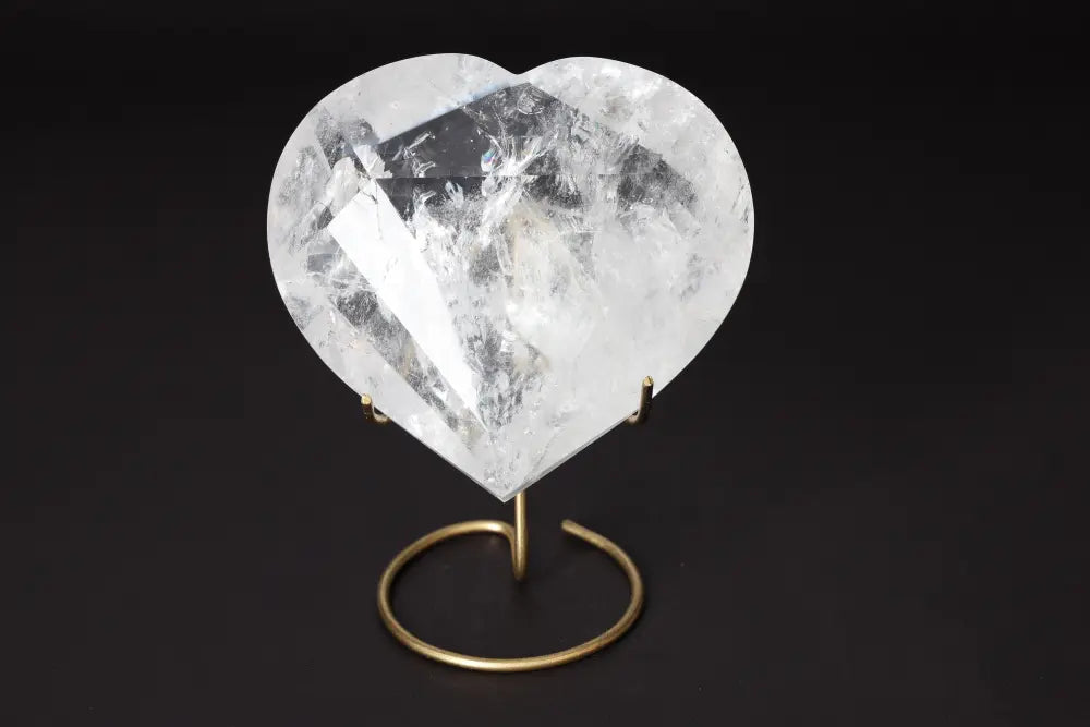 Lemurian Quartz Geometric Heart on a stand showcasing its crystal clarity and geometric design for spiritual connection and luxury.