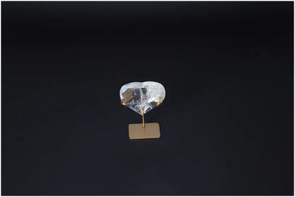 Lemurian Quartz Geometric Heart crystal on stand, showcasing clear quartz properties for purification and negative energy absorption.