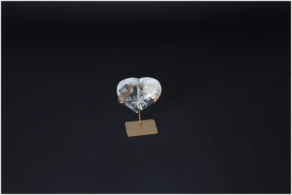 Lemurian Quartz Geometric Heart on stand, used for purification and neutralizing negative energy, positioned against a dark background.