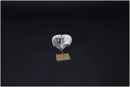 Lemurian Quartz Geometric Heart on stand, used for purification and neutralizing negative energy, positioned against a dark background.