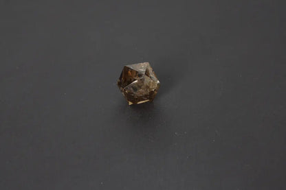 Smoky quartz dodecahedron gemstone on black background