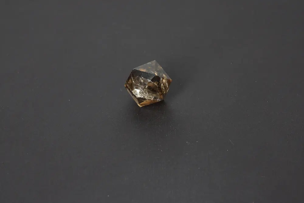 Smoky crystal geometric shape against a dark background