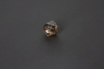 Smoky crystal geometric shape against a dark background
