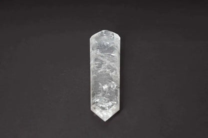 Lemurian Quartz Point crystal against dark background, showcasing horizontal striations and ancient wisdom from Lemurian civilization.