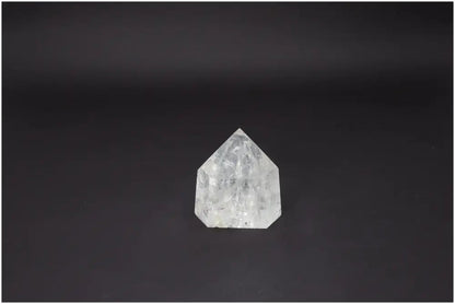 Lemurian Quartz Obelisk on black background, highlighting its clarity and geometric beauty, ideal for spiritual wellness and luxury decor.