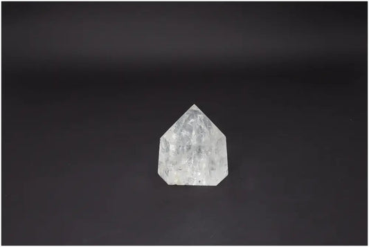 Lemurian Quartz Obelisk on black background, highlighting its clarity and geometric beauty, ideal for spiritual wellness and luxury decor.
