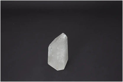 Lemurian Quartz Obelisk by Sylvia Crystals on black background, showcasing its purity and spiritual harmony qualities.