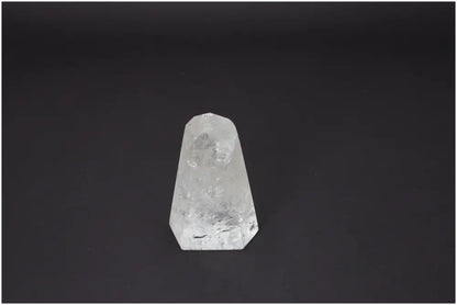 Lemurian Quartz Obelisk against a dark background, showcasing its unique properties associated with chakras and zodiac signs.