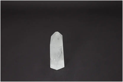 Lemurian Quartz Obelisk on a black background, known for chakra balancing and energetic healing properties.