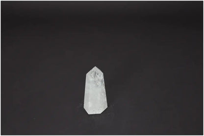 Lemurian Quartz Obelisk crystal on dark background, known for its unique energetic properties and chakra alignment.