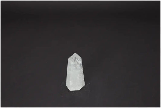 Lemurian Quartz Obelisk crystal on dark background, known for its unique energetic properties and chakra alignment.