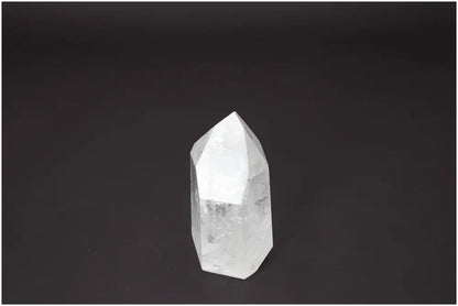Lemurian Quartz Obelisk with unique energetic properties for chakra balancing and zodiac alignment, set against a dark background.