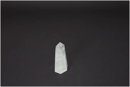 Lemurian Quartz Obelisk on dark background, a crystal with unique properties, enhancing chakra energy and aligning with zodiac signs.