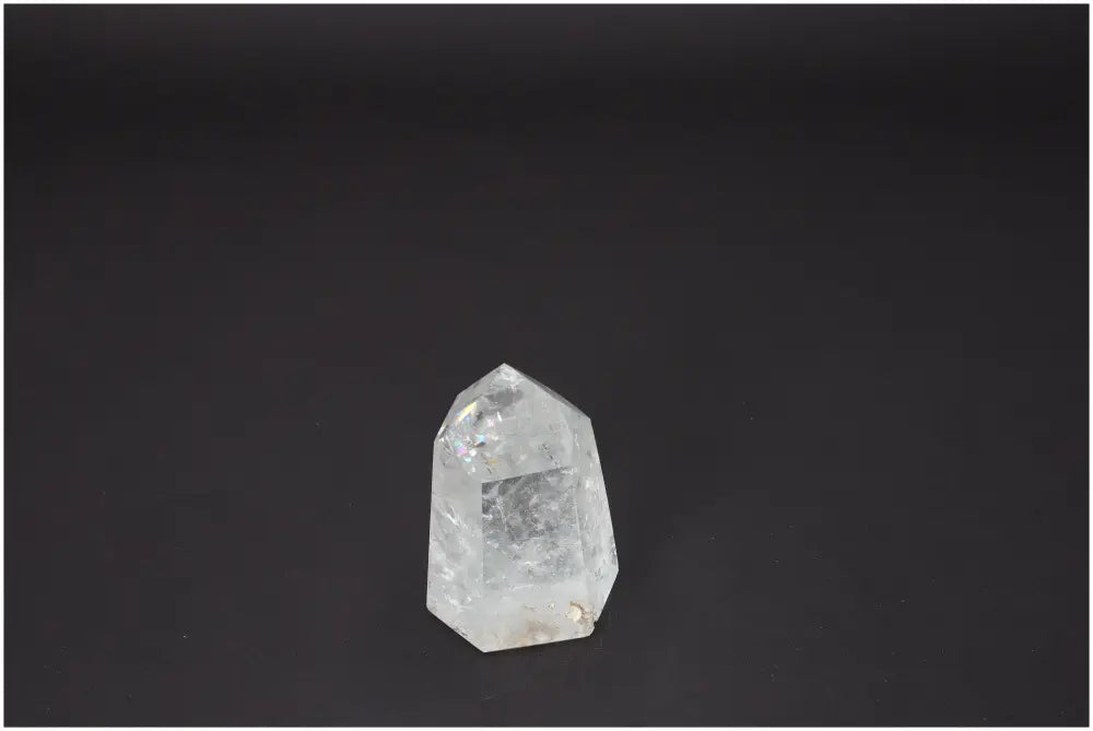 Lemurian Quartz Obelisk on dark background, a spiritual crystal associated with chakras and zodiac energy balancing.