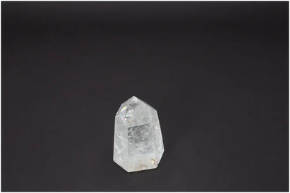 Lemurian Quartz Obelisk on dark background, a spiritual crystal associated with chakras and zodiac energy balancing.