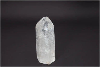 Lemurian Quartz Obelisk, clear and faceted, associated with energy healing and balance in chakras and zodiac signs.