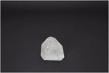 Clear Lemurian Quartz Obelisk on dark background showcasing its unique properties for chakra and spiritual enhancement.