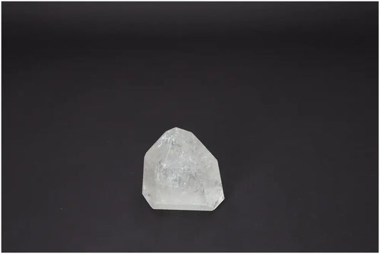 Clear Lemurian Quartz Obelisk on dark background showcasing its unique properties for chakra and spiritual enhancement.