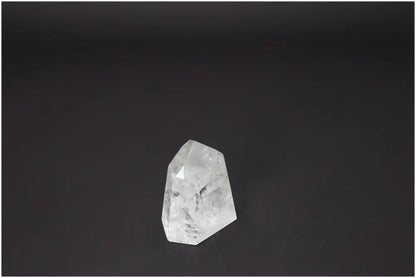 Lemurian Quartz Obelisk on black background, showcasing unique crystal facets for chakra healing and spiritual energy.