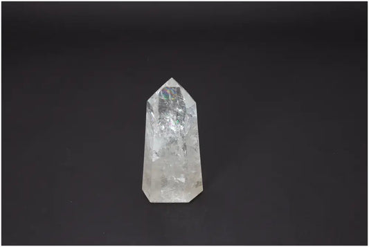 Lemurian Quartz Obelisk on dark background, a crystal known for chakra alignment and spiritual balance.
