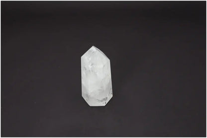 Lemurian Quartz Obelisk against black background, highlighting its natural clarity and spiritual properties for chakra and zodiac energy alignment.