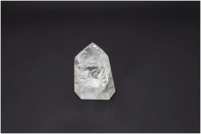 Lemurian Quartz Obelisk on dark background, showcasing unique energetic properties for chakra and zodiac alignment.