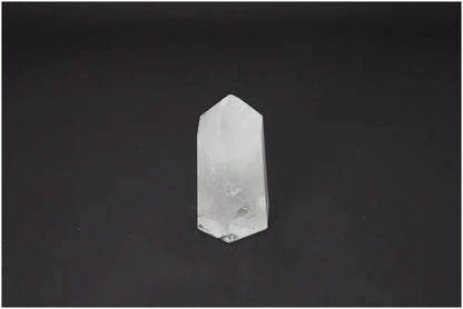 Lemurian Quartz Obelisk on dark background, showcasing its unique spiritual properties for chakras and zodiac signs.