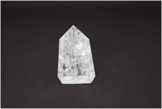Lemurian Quartz Obelisk on dark background, showcasing clear crystal structure with spiritual and energetic properties for chakras.
