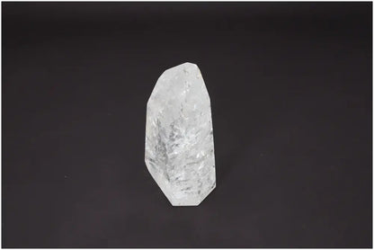 Lemurian Quartz Obelisk on dark background, known for unique chakras, zodiac properties, and spiritual healing energy.