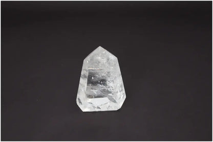 Lemurian Quartz Obelisk on black background, showcasing its clarity and unique energetic properties for chakra alignment.