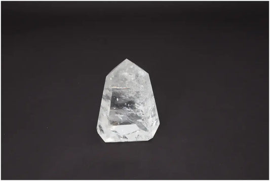 Lemurian Quartz Obelisk on black background, showcasing its clarity and unique energetic properties for chakra alignment.