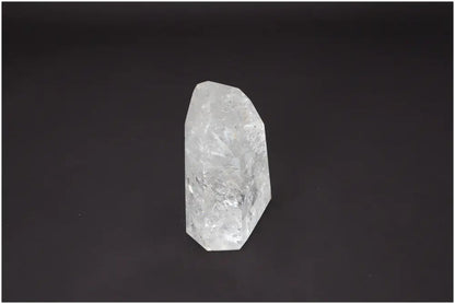 Lemurian Quartz Obelisk with unique energetic properties and chakra associations on a dark background.