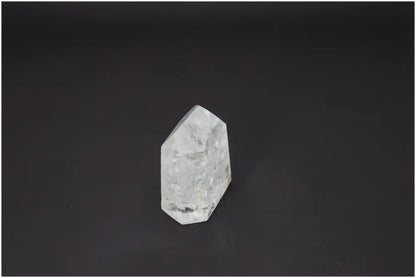 Lemurian Quartz Obelisk supporting chakras and zodiac signs against dark background.