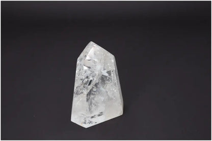 Clear Lemurian Quartz Obelisk on black background showcasing unique crystal formations for chakra and zodiac energy alignment.